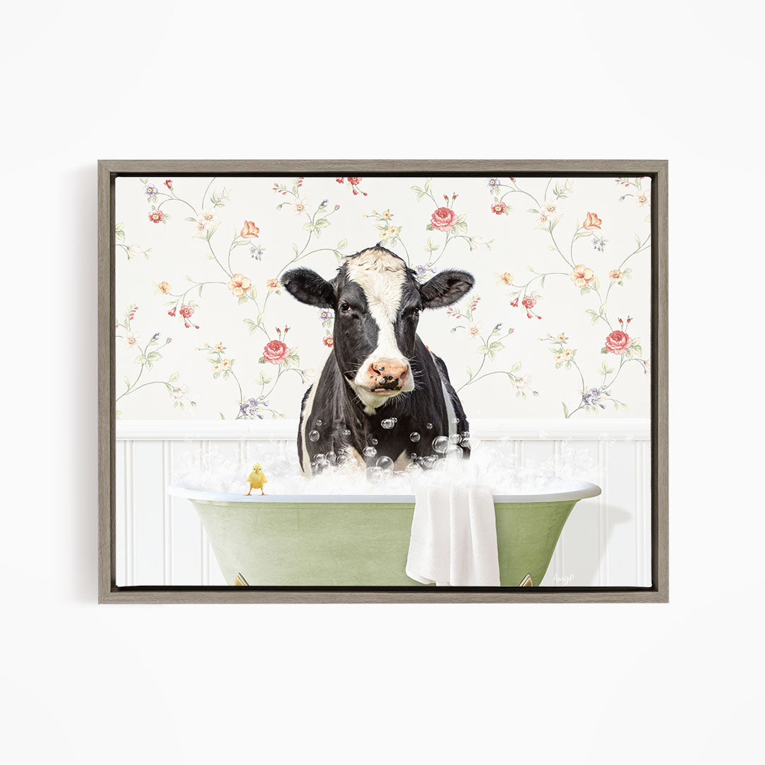 A black and white cow is sitting in a green bathtub filled with bubbles, with a yellow bird perched on the edge of the tub.