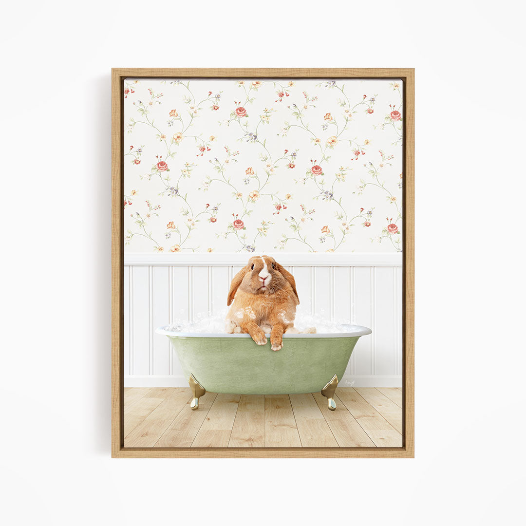 A brown rabbit sitting in a green bathtub filled with water, with a floral wallpaper in the background.