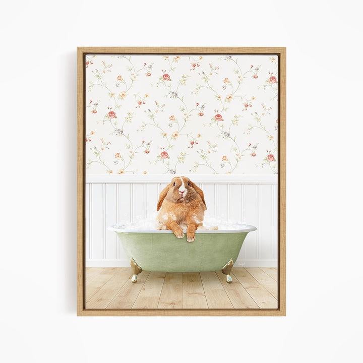 A brown rabbit sitting in a green bathtub filled with water, with a floral wallpaper in the background.