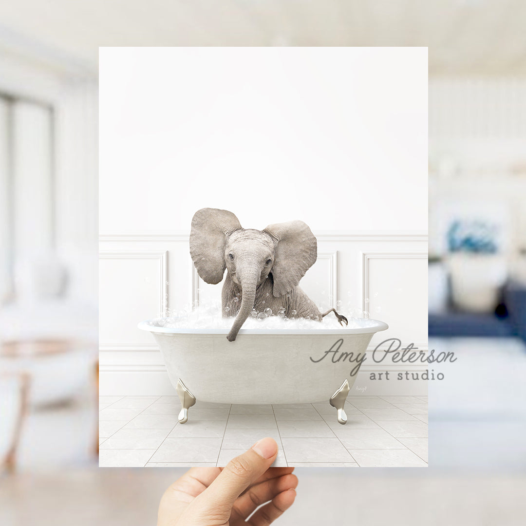 a person holding up a card with an elephant in a bathtub