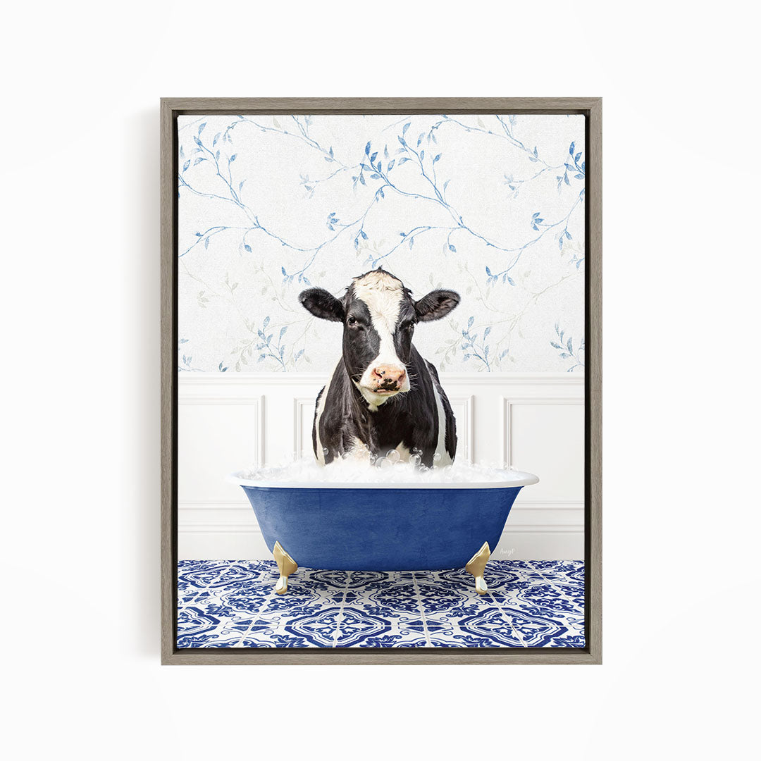 A black and white cow is sitting in a blue bathtub filled with water, with a patterned tile floor in the background.