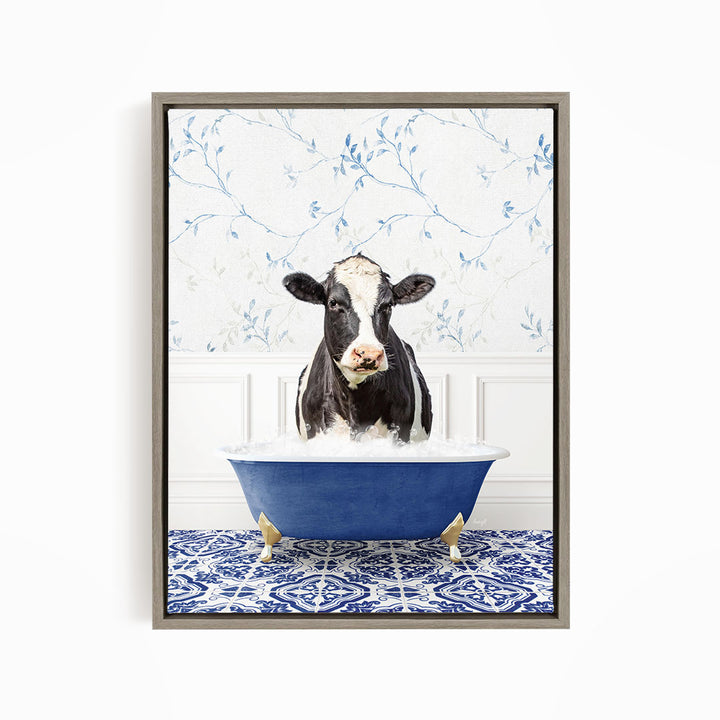 A black and white cow is sitting in a blue bathtub filled with water, with a patterned tile floor in the background.