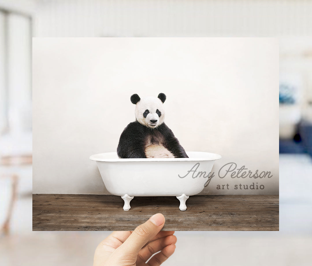 a panda bear sitting in a bath tub