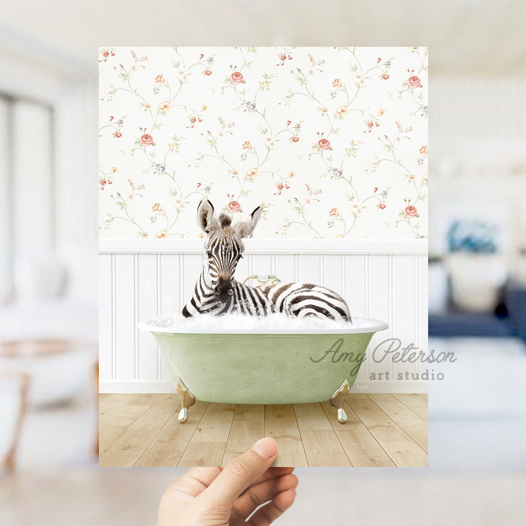 a hand holding up a picture of a zebra in a bathtub