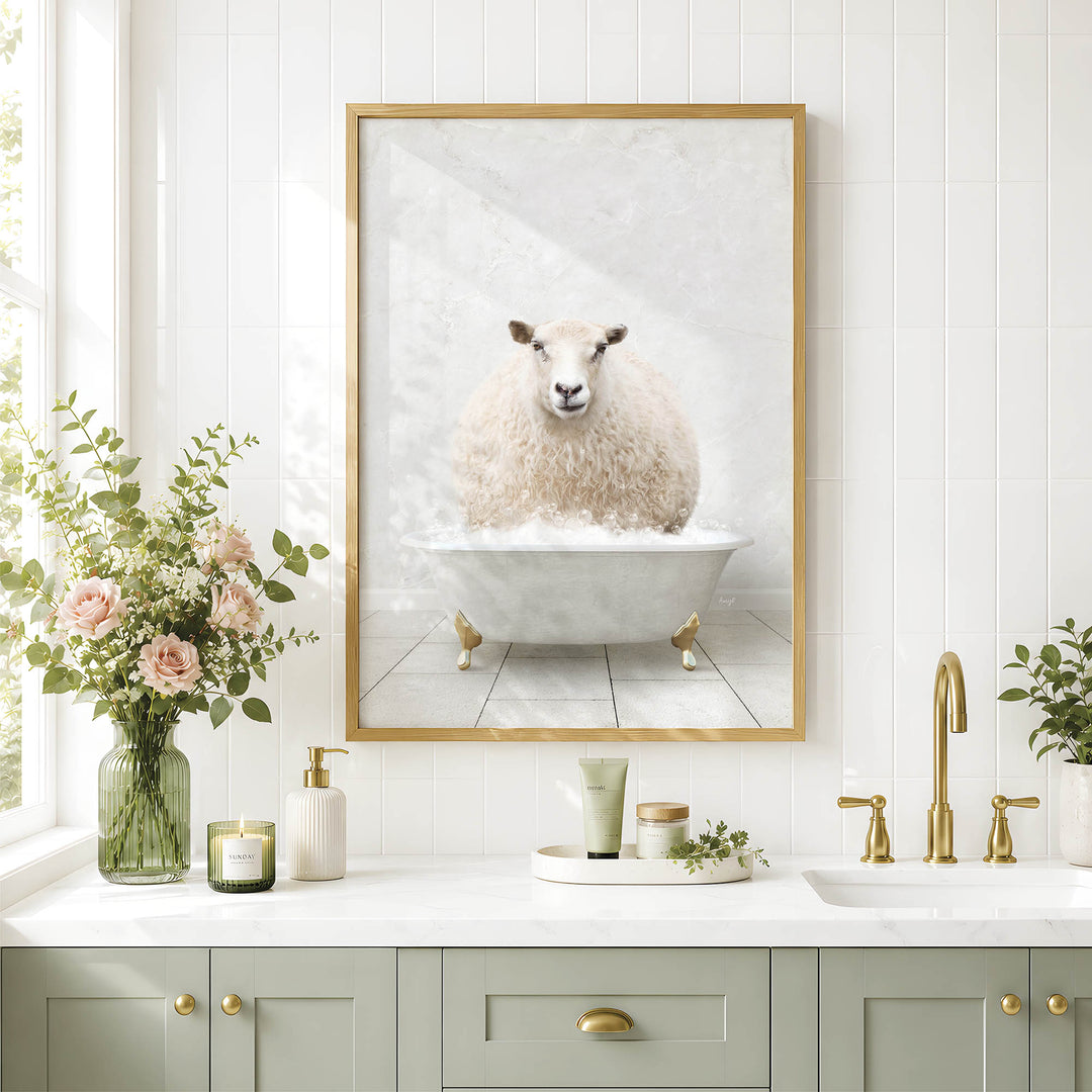 a bathroom with a framed picture of a sheep sitting in a bathtub, surrounded by flowers and candles.