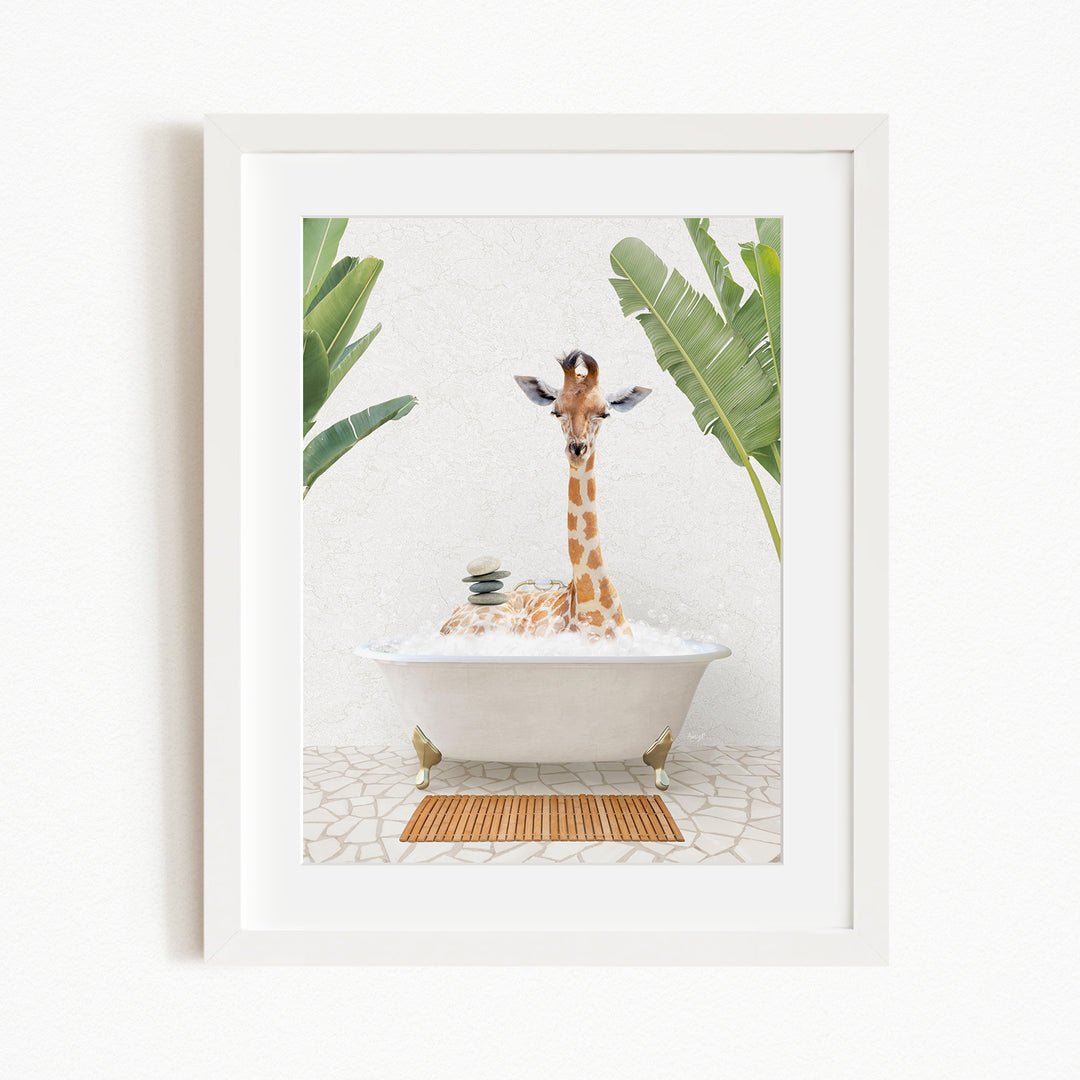 A giraffe standing in a white bathtub filled with bubbles, surrounded by green leaves, creating a whimsical and playful scene.