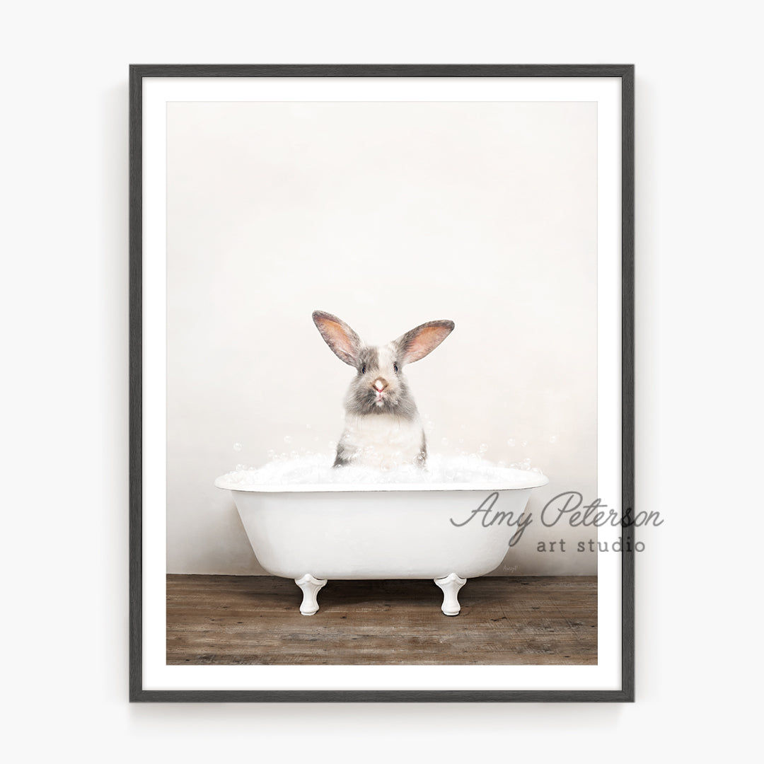 a rabbit is sitting in a bathtub with foam