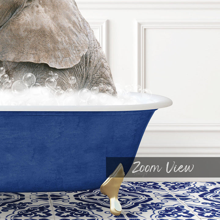 A large blue bathtub filled with soapy water, with a gold faucet and a gold bathtub leg visible.