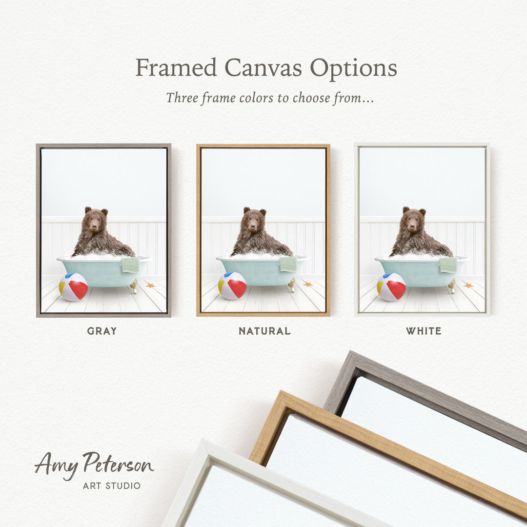 The image is a framed canvas option showcasing three different frame colors: gray, natural, and white. The canvas features a brown bear sitting in a bathtub with a beach ball and starfish nearby.