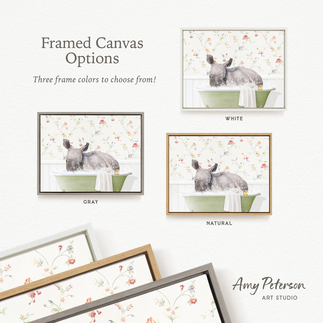 The image is a framed canvas with three different options for the color of the frame: white, gray, and natural. The canvas depicts a gray rhino sitting in a green bathtub, surrounded by a floral pattern.