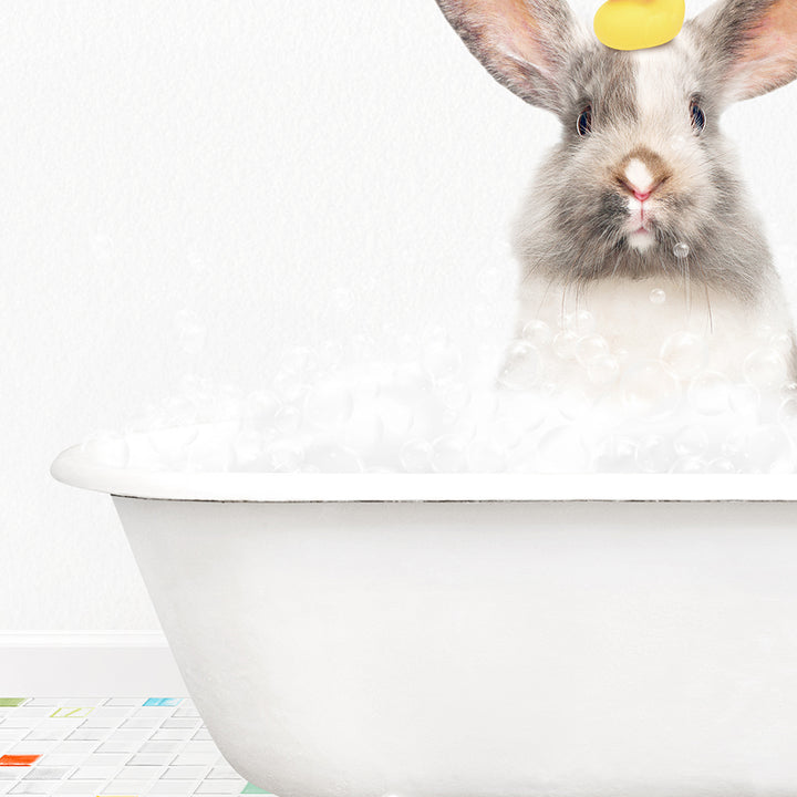 a rabbit in a bathtub with a yellow tag on its ear