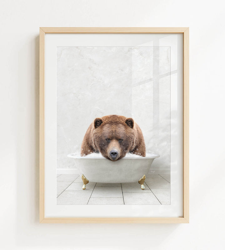 A brown bear is sitting in a white bathtub, appearing relaxed and content.