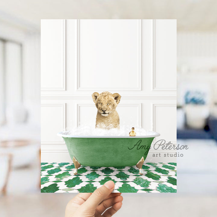 a hand holding a card with a picture of a baby lion in a bathtub