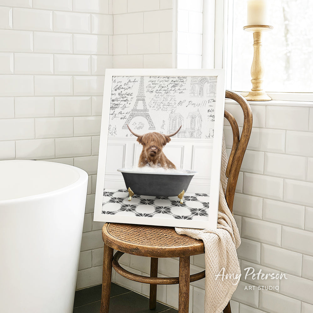 A framed image of a bull with horns sitting in a bathtub, surrounded by a tiled bathroom setting.