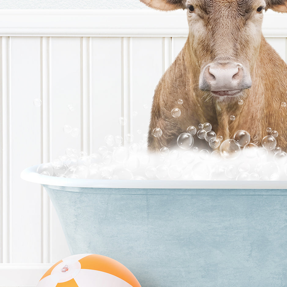 a cow in a bathtub with bubbles and a beach ball