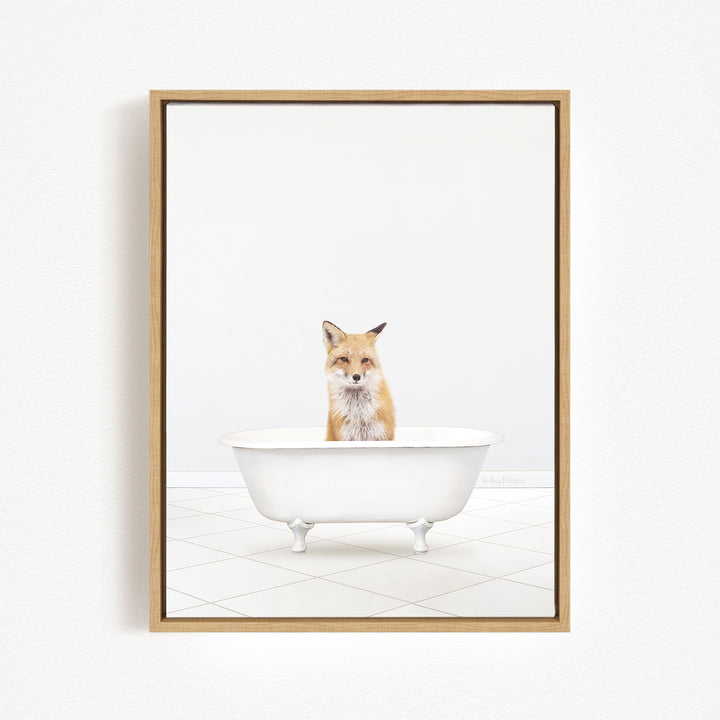 A fox is sitting in a white bathtub, looking directly at the camera.