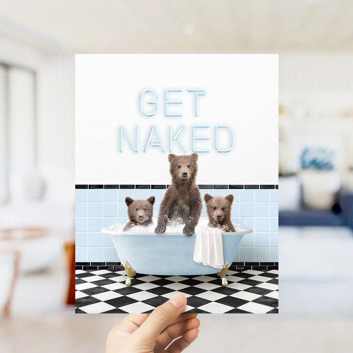 A hand holding a printed image of three bears sitting in a bathtub, with the text "GET NAKED" displayed above them.