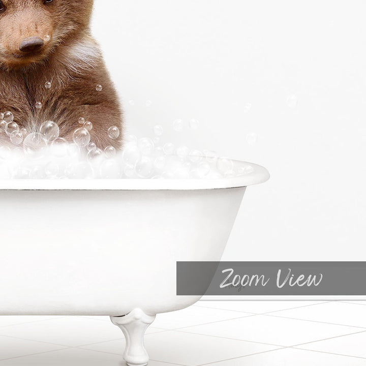 A brown bear sitting in a white bathtub filled with bubbles, as if enjoying a bath.