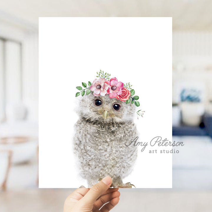 a hand holding a card with an owl wearing a flower crown