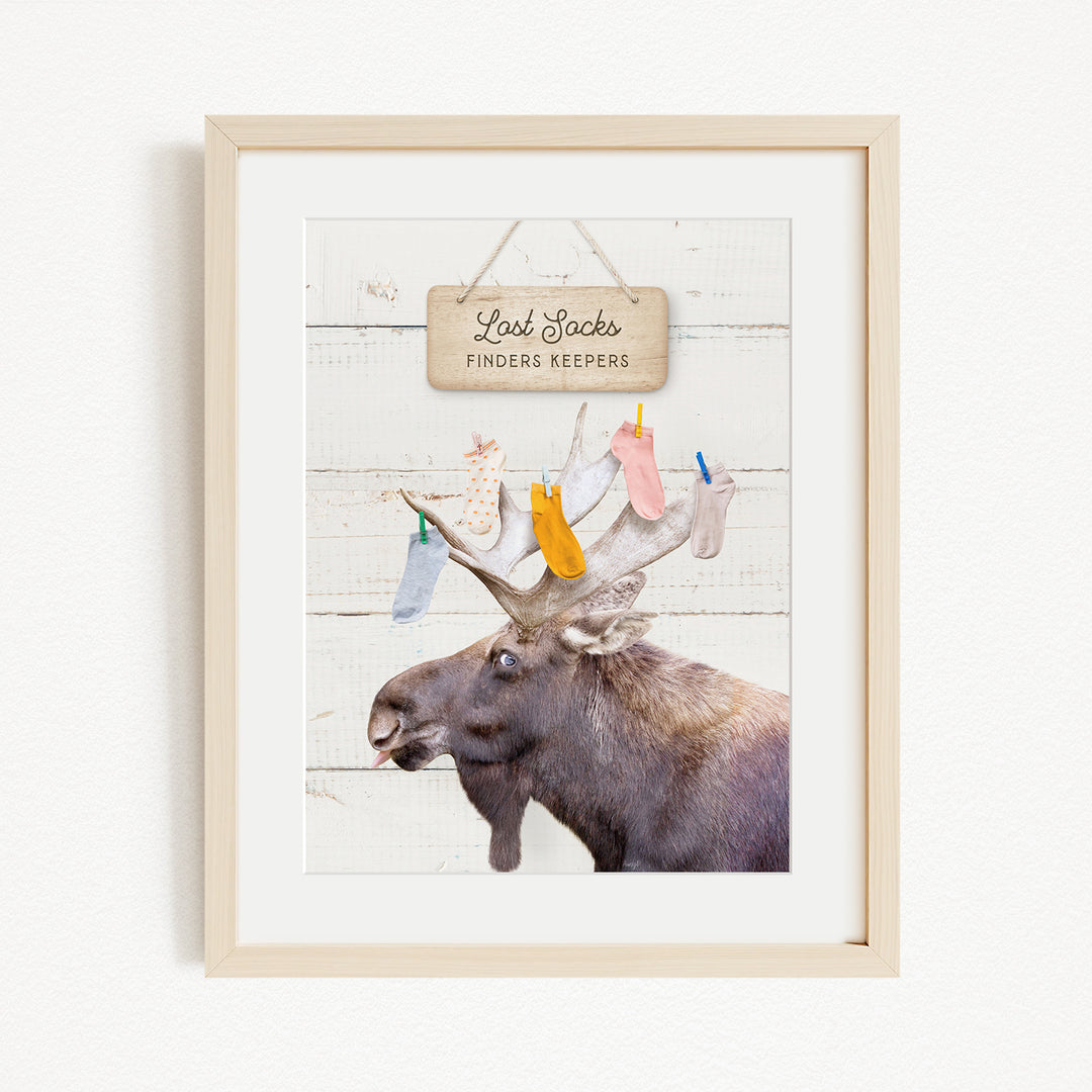 A framed image of a moose with a sign above it that says "Red Socks Finders Keepers".