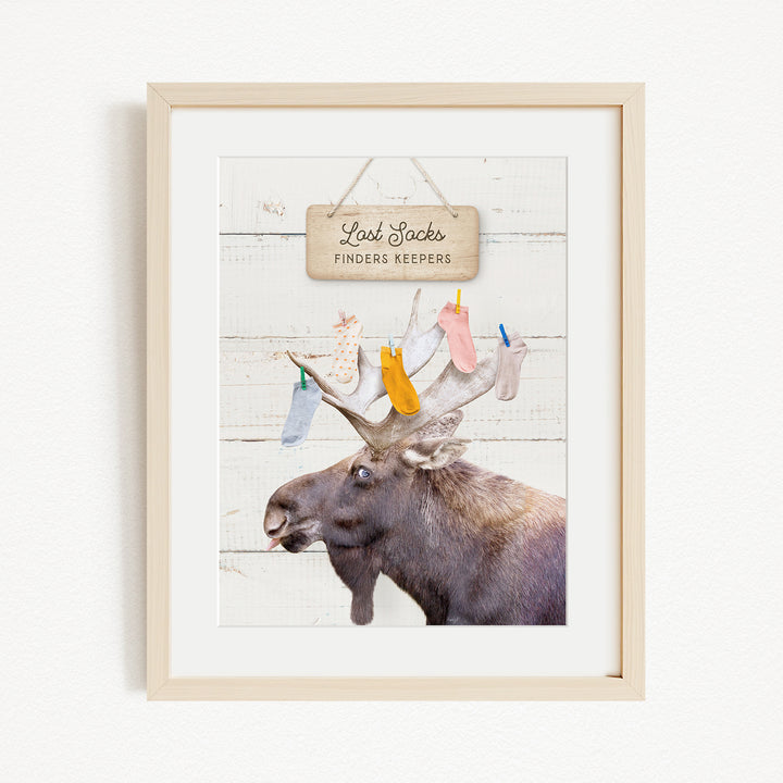 A framed image of a moose with a sign above it that says "Red Socks Finders Keepers".