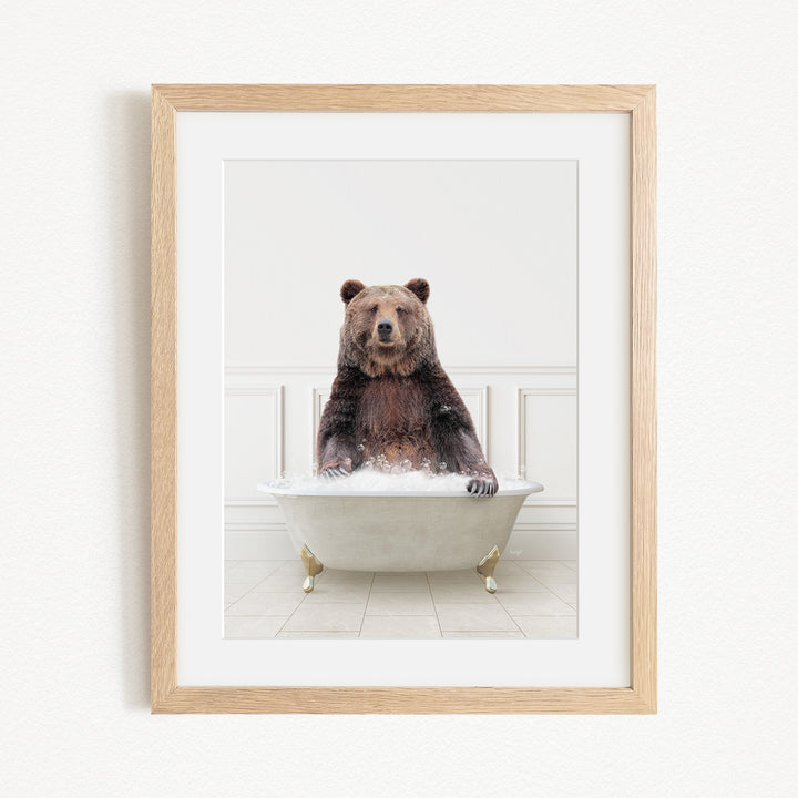 A brown bear sitting in a white bathtub filled with water, creating a whimsical and playful scene.