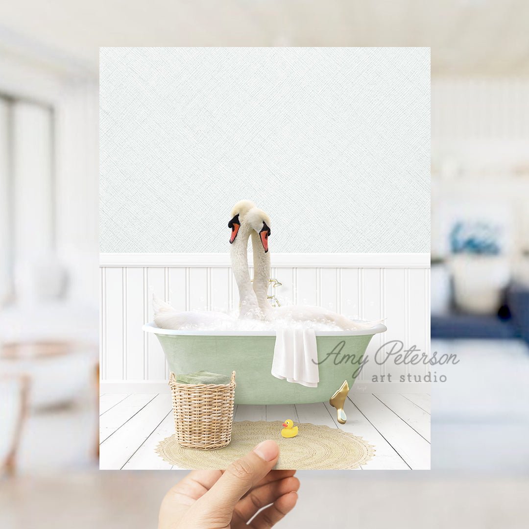 a person holding up a picture of a swan in a bathtub