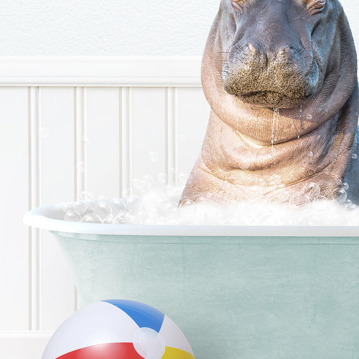 a hippo in a bathtub with a beach ball