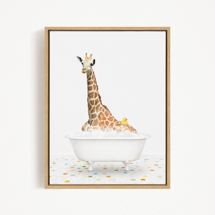 A giraffe is sitting in a white bathtub filled with bubbles, with a yellow duck resting on its back.
