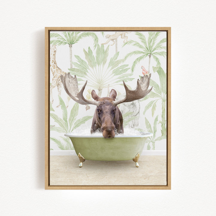 A moose with large antlers is sitting in a green bathtub, surrounded by tropical foliage and palm trees.