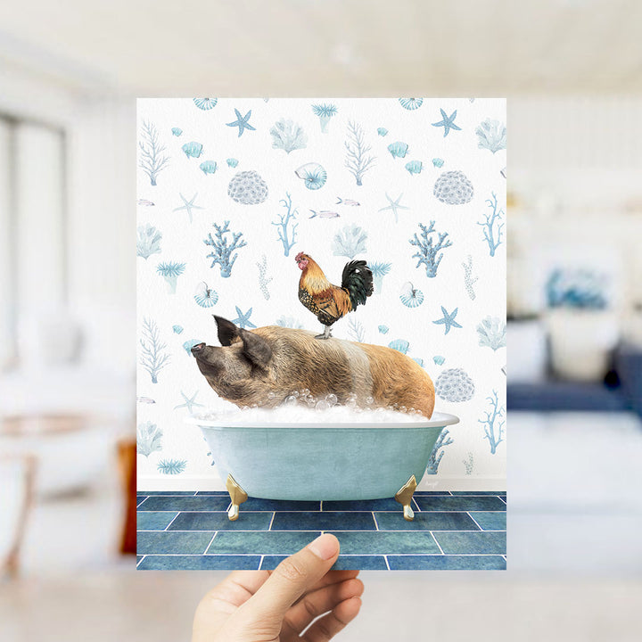 A hand is holding up a print featuring a pig sitting in a bathtub, with a rooster perched on its back.