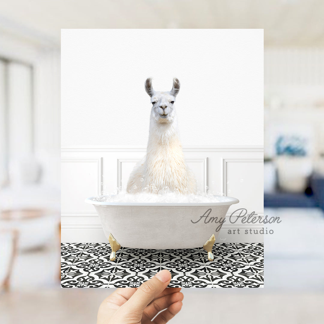 a llama in a bathtub with a hand holding a card