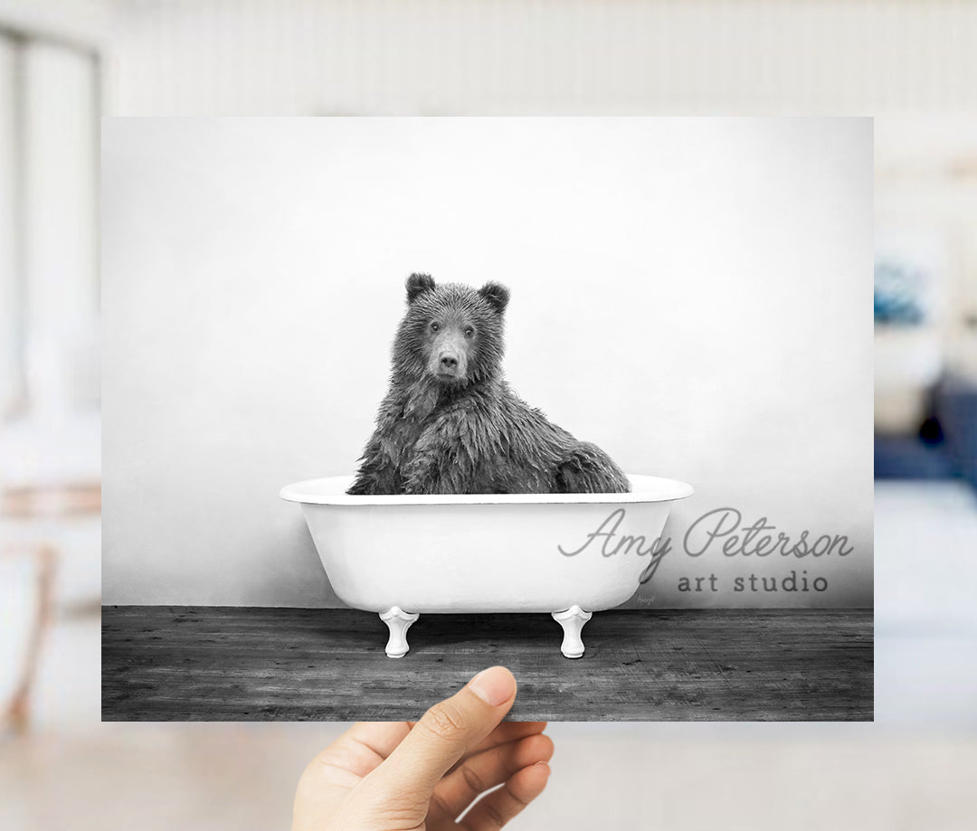 a black and white photo of a bear in a bathtub