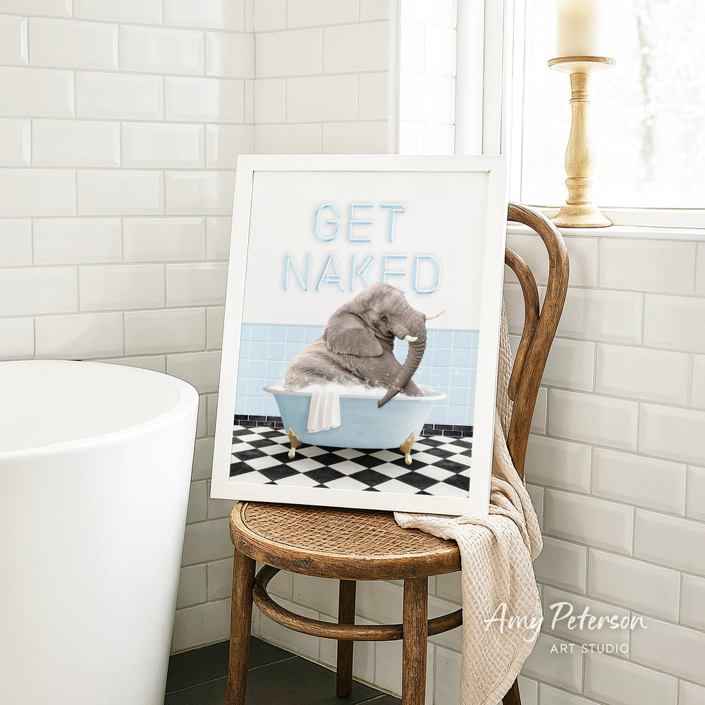 A framed image of a gray elephant sitting in a blue bathtub, with the text "GET NAKED" written on the frame.