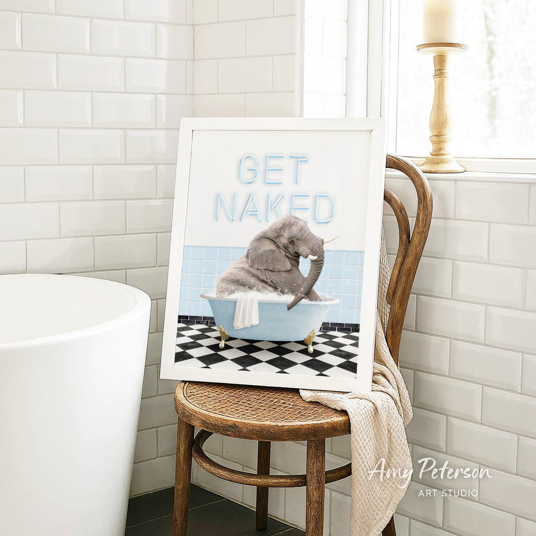 A framed image of a gray elephant sitting in a blue bathtub, with the text "GET NAKED" written on the frame.