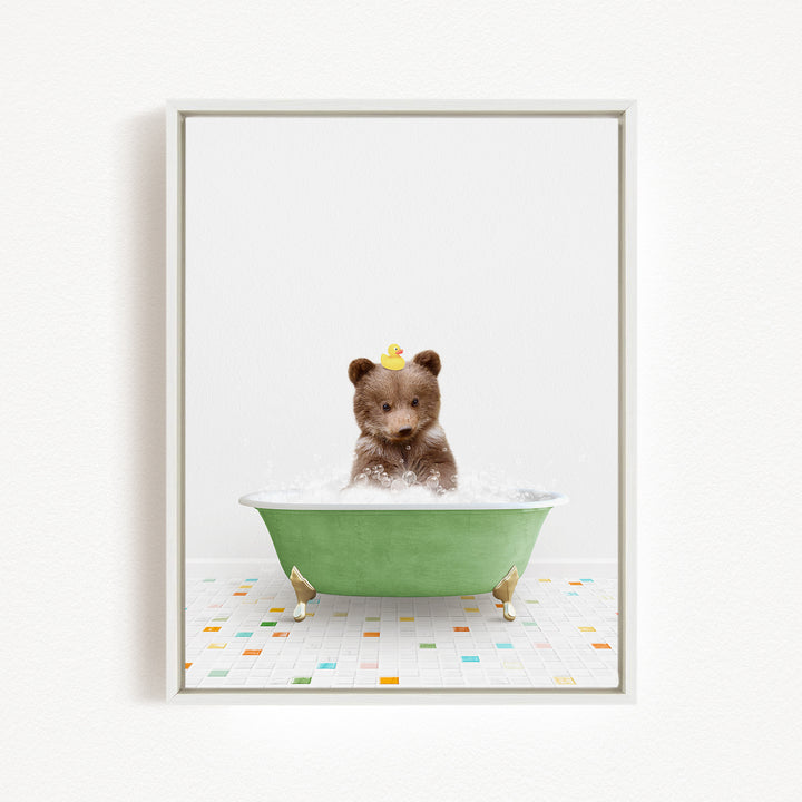 A brown bear sitting in a green bathtub filled with water, with a rubber duck floating on its head.