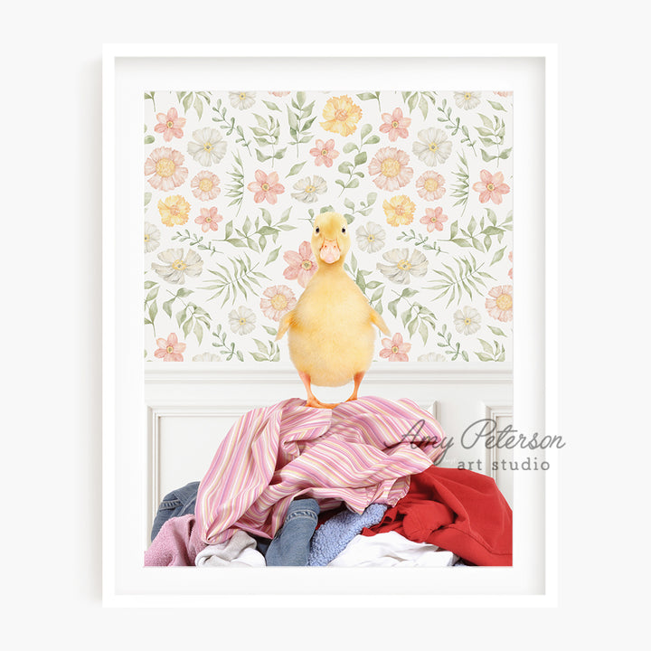 a yellow duck sitting on top of a pile of clothes