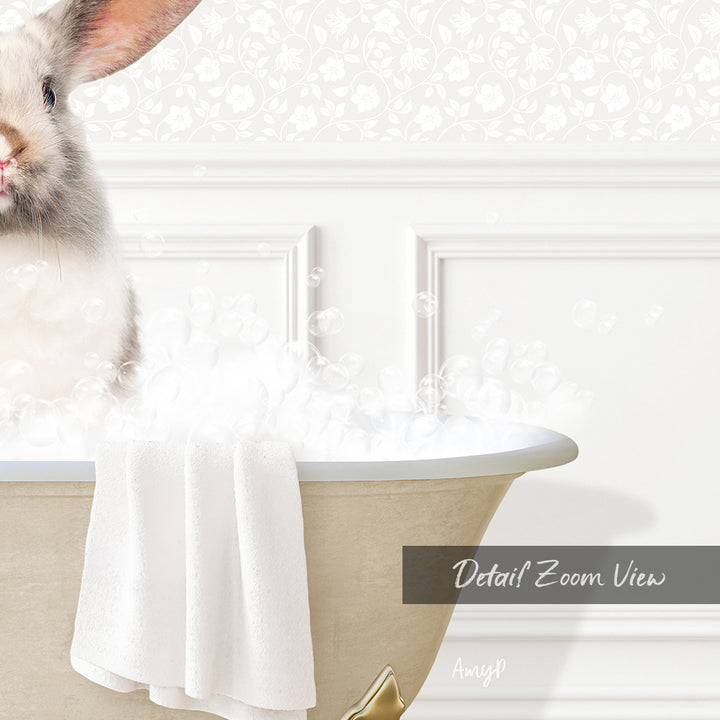 A white rabbit sitting in a bathtub filled with bubbles, with a towel draped over the side of the tub.