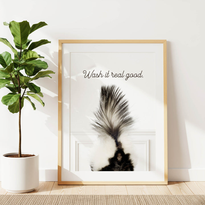 a framed picture of a skunk's tail with the text "Wash it real good."
