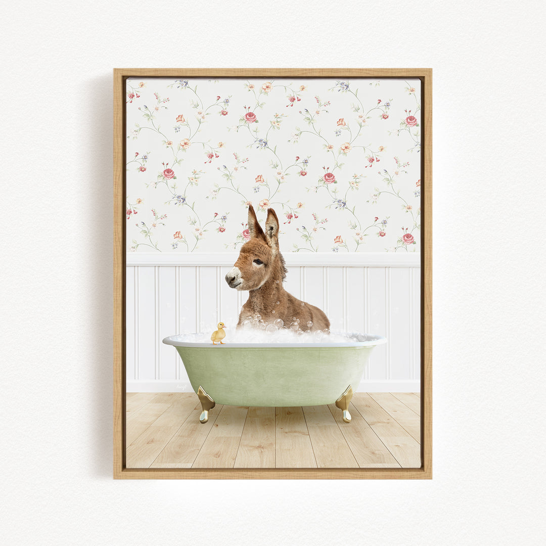 A donkey is sitting in a green bathtub filled with water, surrounded by a floral wallpaper and a yellow rubber duck.