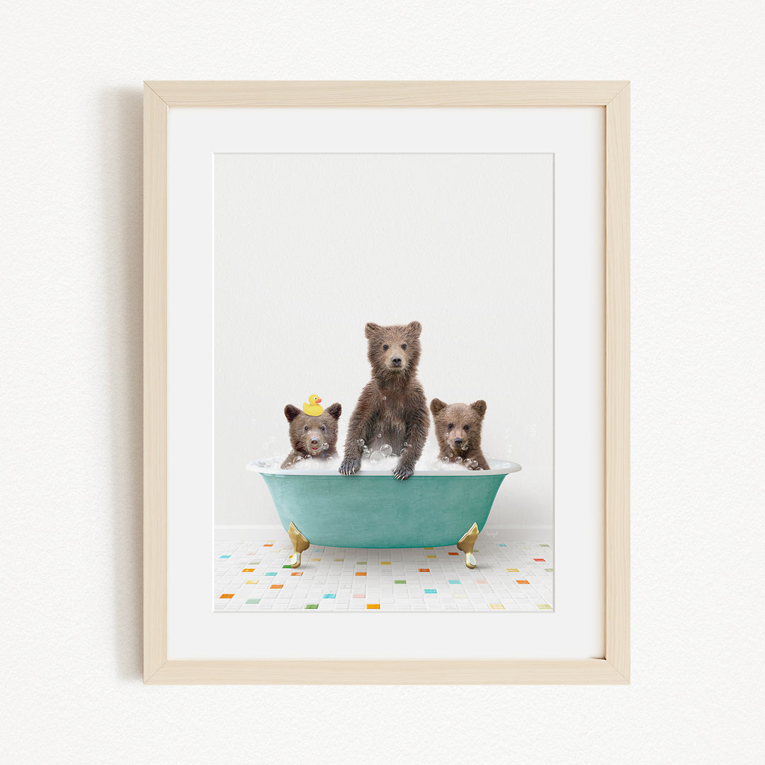 A framed image depicting three bears sitting in a bathtub filled with water and floating on their backs.