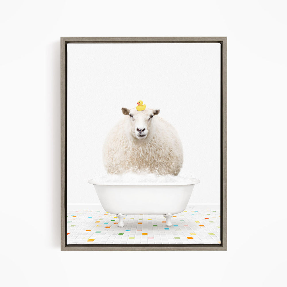 A fluffy white sheep sits in a white bathtub filled with bubbles, with a yellow rubber duck perched on its head.