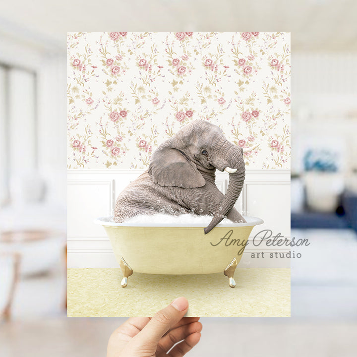 a person holding up a picture of an elephant in a bathtub