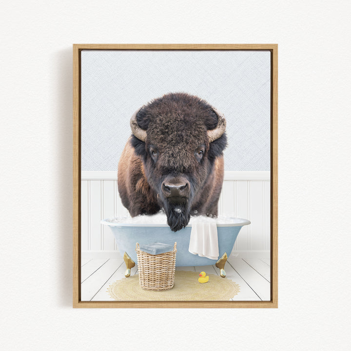 A buffalo with a long beard is sitting in a blue bathtub, surrounded by a basket of toys and a yellow rubber duck.