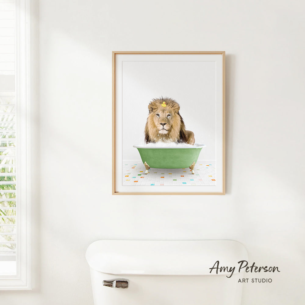 A framed image of a lion sitting in a green bathtub, with a white toilet in the foreground.