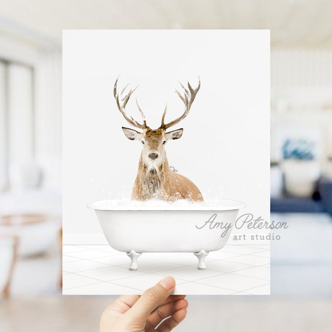 a person holding up a card with a picture of a deer in a bathtub