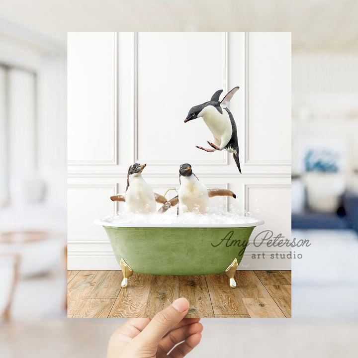 a hand holding a card with penguins in a bathtub