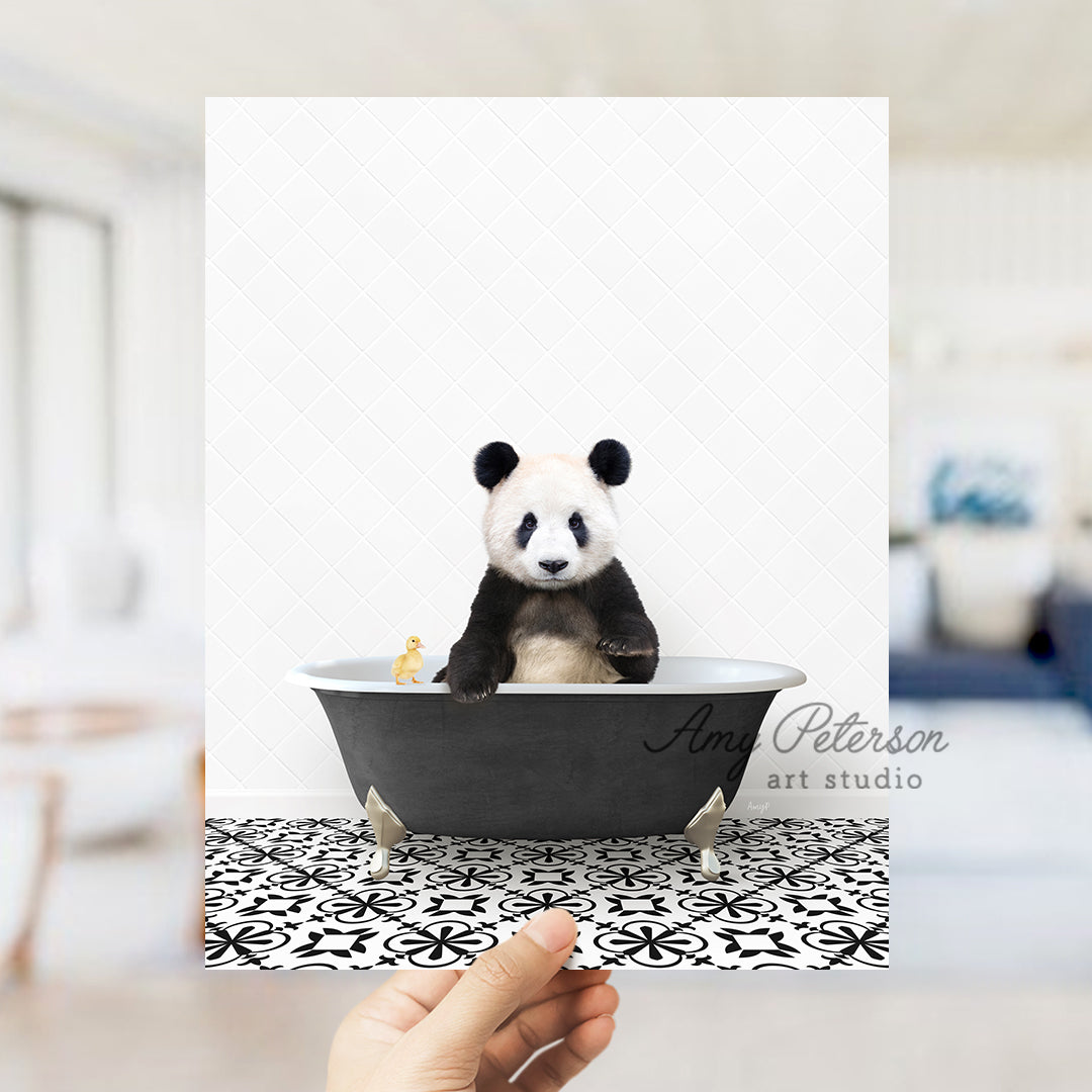 a panda bear sitting in a black and white bath tub