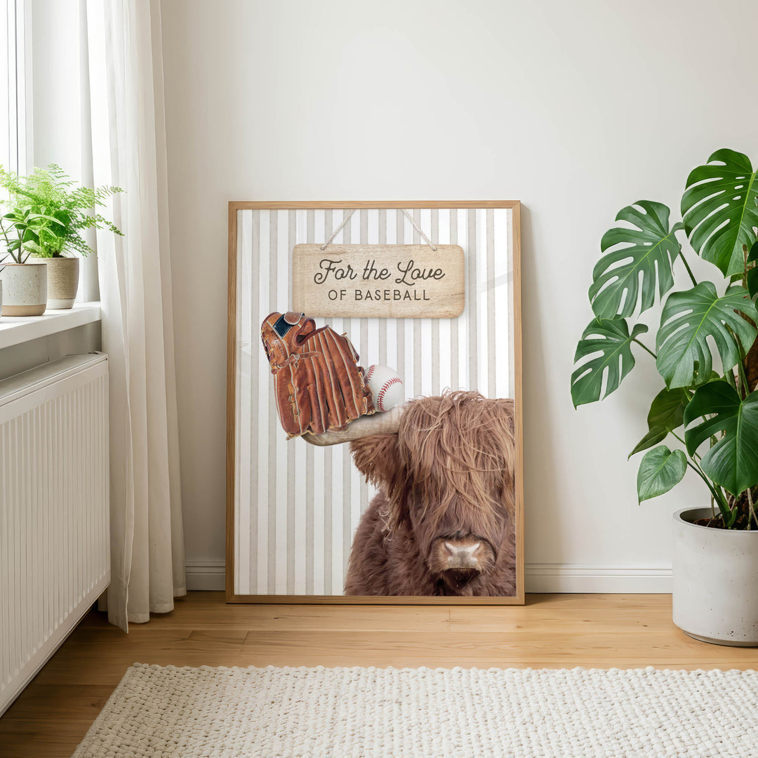 a framed poster with a close-up of a cow's head and a baseball glove, along with the text "For the Love of Baseball" displayed on the poster.