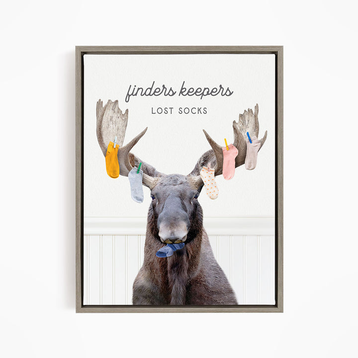 A moose with a pair of socks hanging from its antlers, with the text "finders keepers" and "lost socks" above the image.